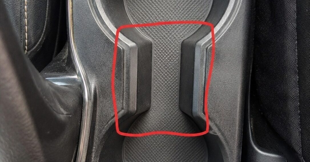 What is the purpose of the strange spacing between the cup holders in the car?