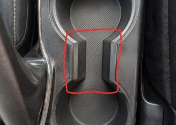 What is the purpose of the strange spacing between the cup holders in the car?