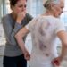 I returned home to visit my elderly mother, but when I offered to help her bathe, she suddenly pulled away in fear. “Please,” she whispered, holding her coat tightly around herself. “Don’t take it off.”