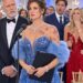 “At his company party, my husband struck my shoulder and whispered, “Go home. She belongs beside me tonight.” His mistress stood nearby in a tight red gown, pretending not to hear. I adjusted my dress and said, “No. I think I’ll stay for the announcement.”