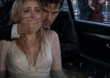 My husband drove the car into the river with my brother and me trapped inside, but when the water had already reached my neck, the man who had been “paralyzed” for 15 years stood up from his wheelchair, k:ick:ed the door open, and whispered, “Play d:ea:d. He’s watching.” I didn’t ask any questions… until I saw who was waiting for my husband on the shore.