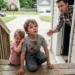 My six-year-old nephew dragged his broken leg across seven blocks of pavement to reach my porch, with his starving three-year-old sister clinging to his shirt. I was fixing a loose hinge when I heard scraping on the steps and turned to see him crawling toward me, pale, shaking, and whispering, “She locked us downstairs again.”