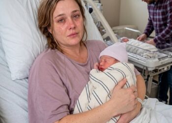 I lost one of my twins during labor. When the nurse gently placed my surviving baby boy in my arms, she leaned close and whispered, “Before you trust your husband, watch the video I just sent you.”