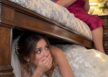 On my wedding night, I hid beneath the bed to surprise my husband- but a woman entered our room and put a call on speaker. I recognized the voice on the other end—and what I heard made me unbelievably
