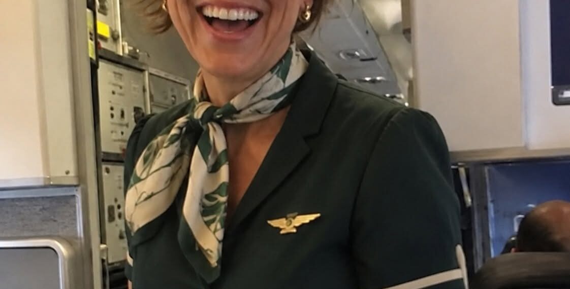 My flight attendant wife had to work on our anniversary, so I secretly booked a seat on the same flight to surprise her, but then the pilot made an announcement that left me completely frozen.