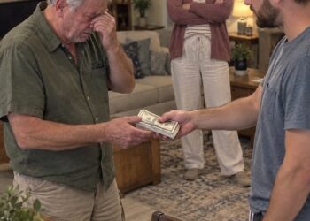 My father was standing in the middle of my kitchen asking to borrow $1,000. His hands were shaking with embarrassment. Before he could even explain what he needed the money for, my wife looked across the room and said coldly: “Tell him to find another job. We’re not a bank.”